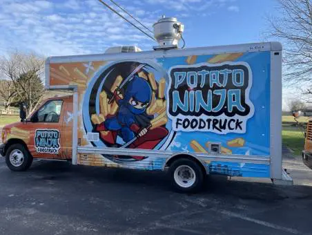 A food truck with a cartoon character on the side.